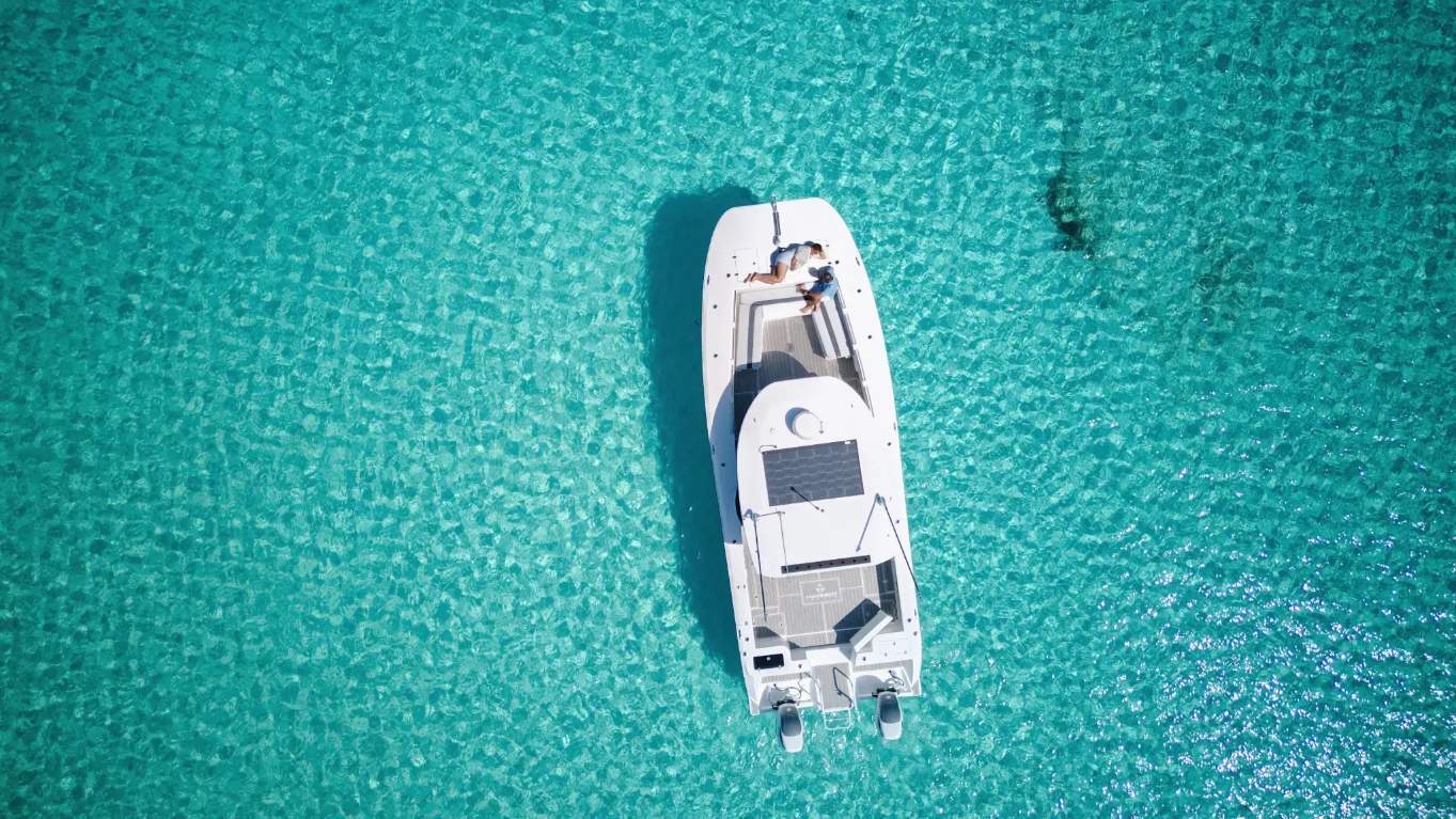 Boat over turquoise water off Grand Bahama